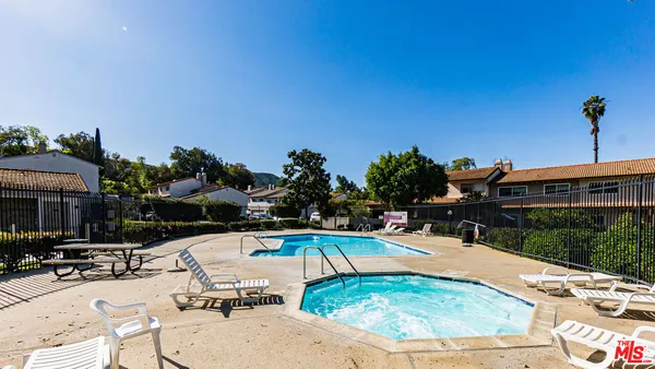 a swimming pool with barbeque oven outdoor seating