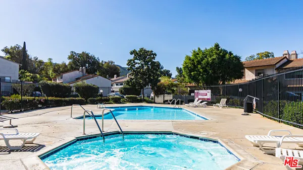 a view of a swimming pool with a lounge chairs
