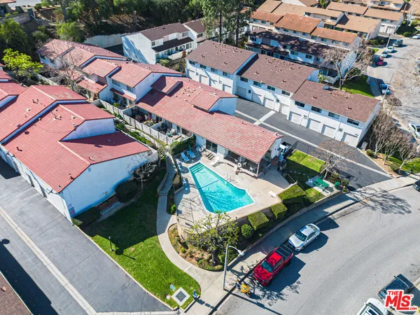 an aerial view of a house with garden space and street view