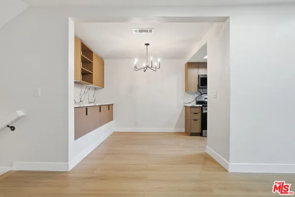 a view of a room with wooden floor
