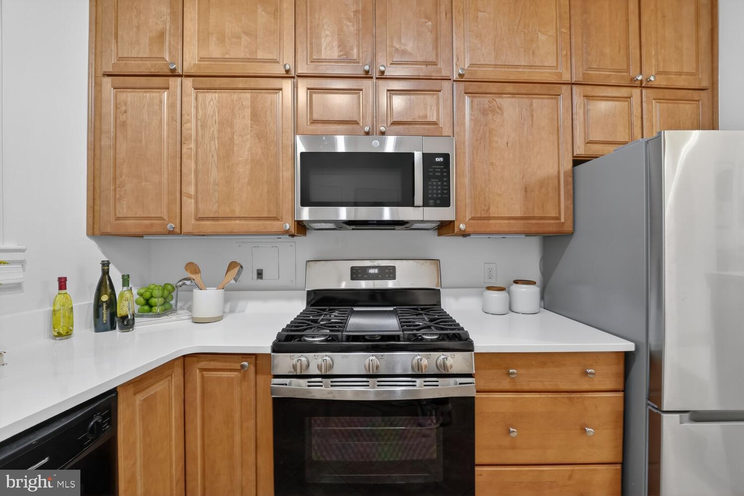 2126 Connecticut Avenue Northwest, Unit 17 Washington, DC 20008 - Photo 14 of 36 a kitchen with stainless steel appliances granite countertop a stove a microwave and a refrigerator