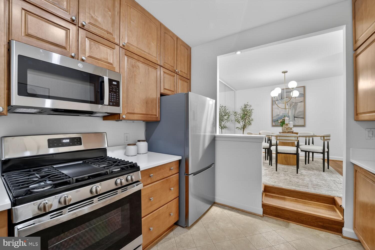 2126 Connecticut Avenue Northwest, Unit 17 Washington, DC 20008 - Photo 15 of 36 a kitchen with stainless steel appliances kitchen island granite countertop a stove a refrigerator and a microwave