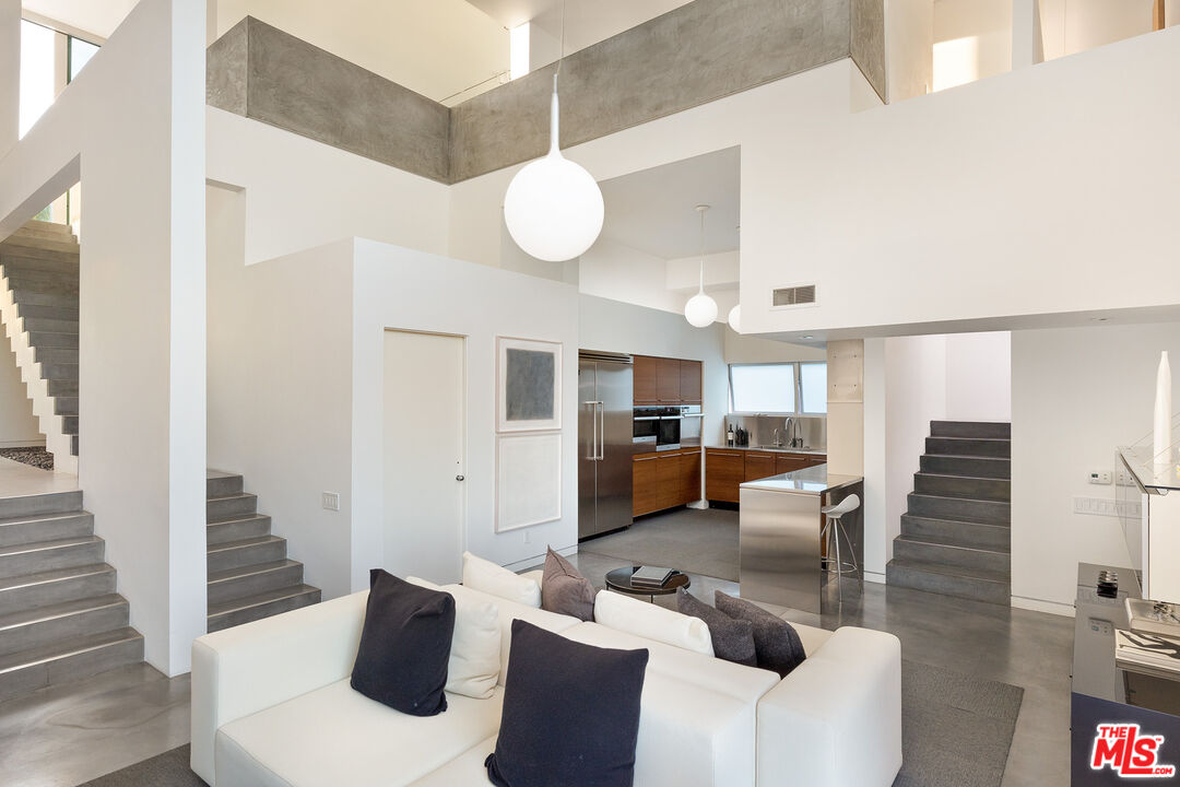 7800 West 81st Street Playa del Rey, CA 90293 - Photo 6 of 27 a living room with couches and kitchen view with wooden floor