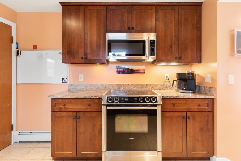 685 Bay Road Hamilton, MA 01982 - Photo 5 of 29 a kitchen with stainless steel appliances granite countertop wooden cabinets and a stove top oven