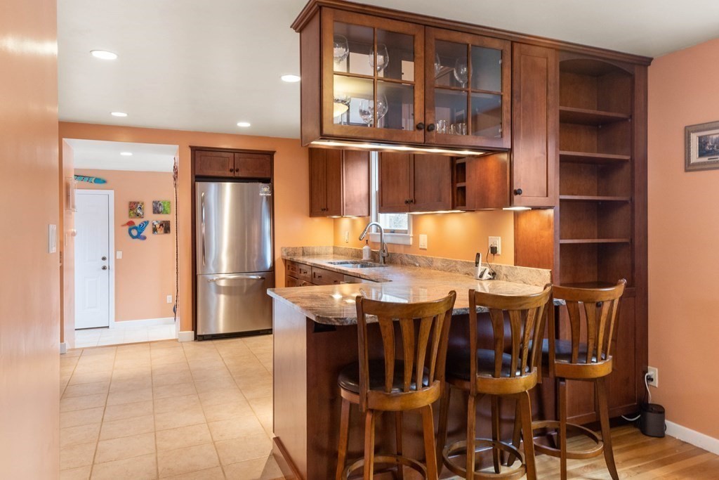 685 Bay Road Hamilton, MA 01982 - Photo 8 of 29 a kitchen with a dining table chairs and refrigerator