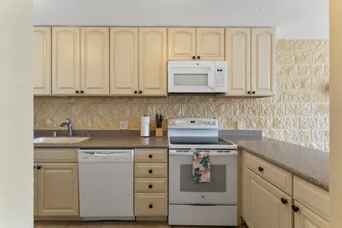 a kitchen with cabinets appliances and a sink