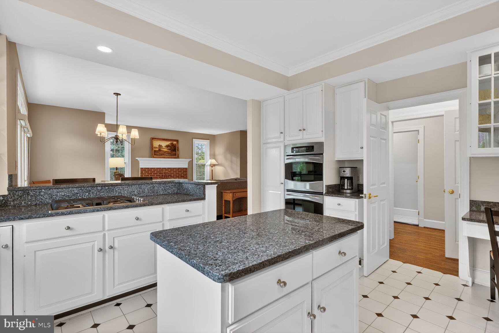 5206 Little Falls Road Arlington, VA 22207 - Photo 13 of 49 a kitchen with granite countertop a sink a counter top space and cabinets