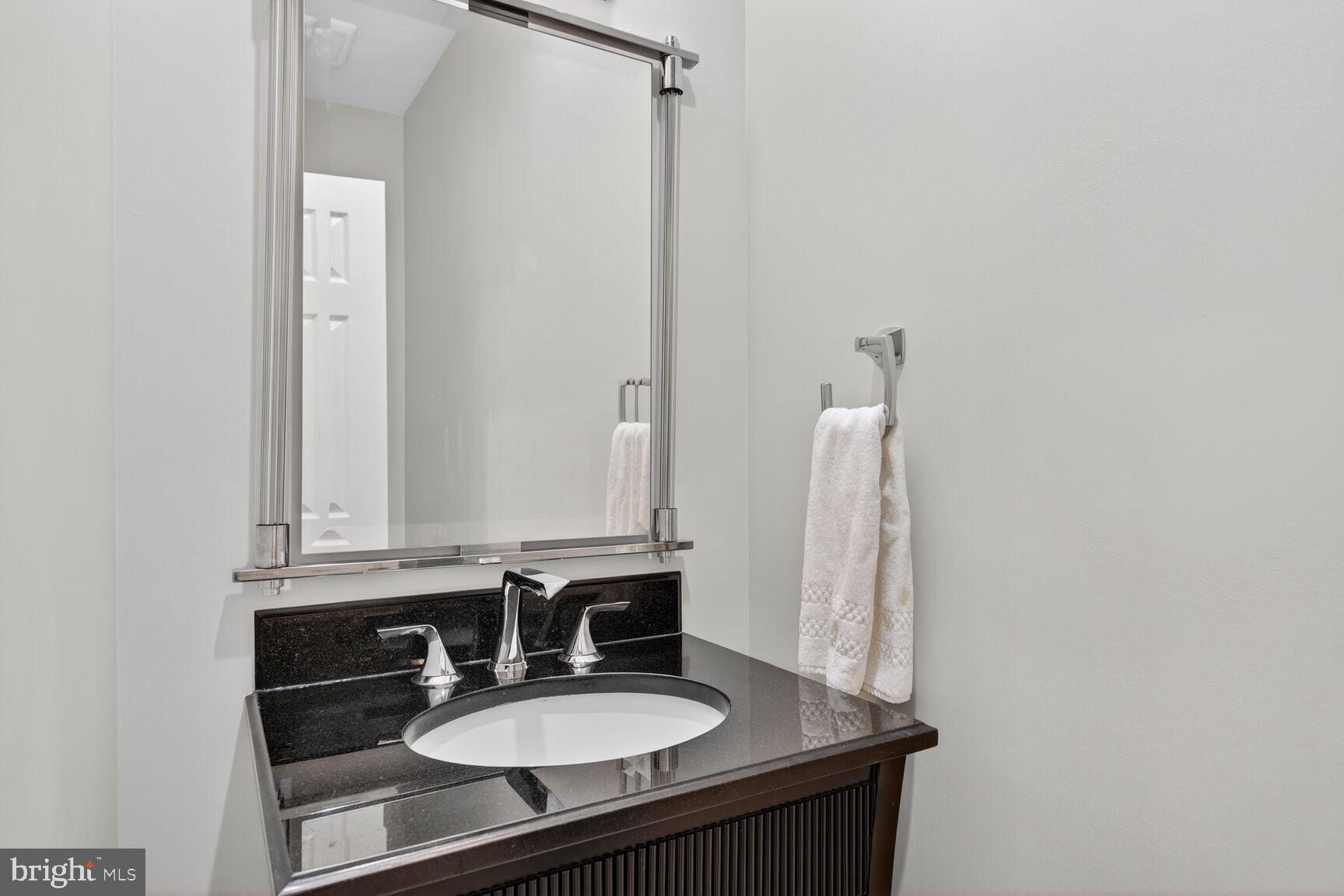 5206 Little Falls Road Arlington, VA 22207 - Photo 20 of 49 a bathroom with a sink and a mirror