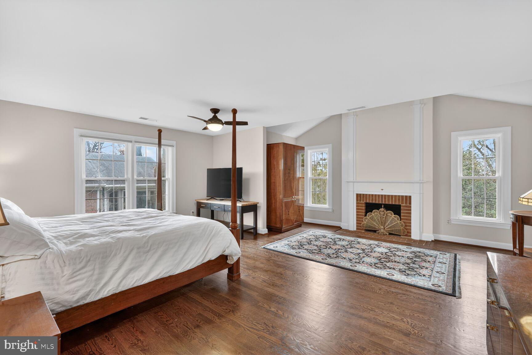 5206 Little Falls Road Arlington, VA 22207 - Photo 26 of 49 a bedroom with a large bed and a fireplace