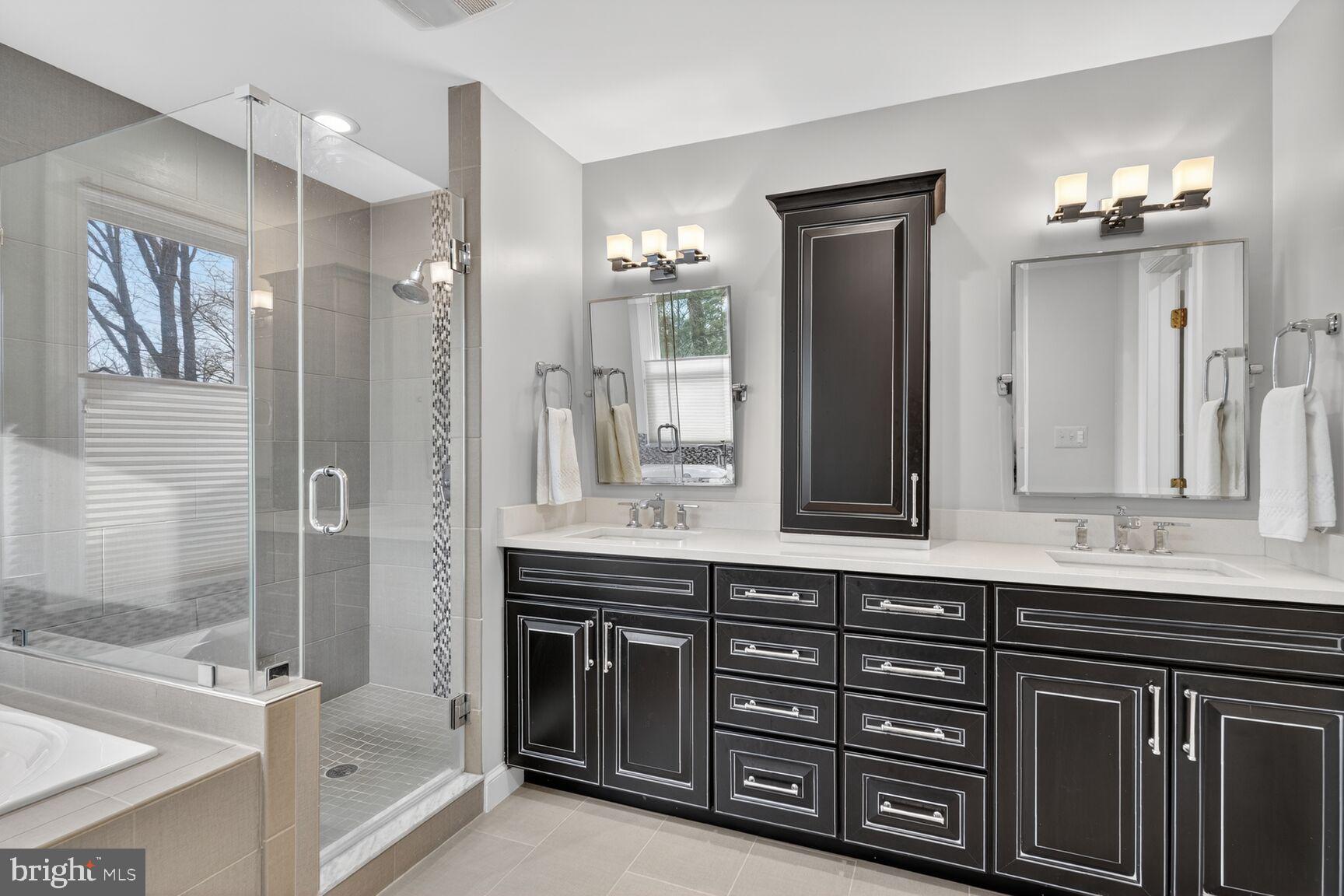 5206 Little Falls Road Arlington, VA 22207 - Photo 28 of 49 a bathroom with a granite countertop sink a large mirror and a shower