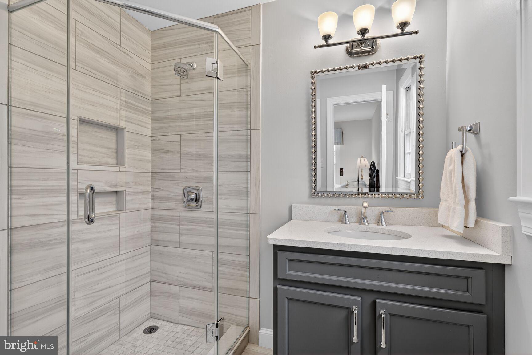 5206 Little Falls Road Arlington, VA 22207 - Photo 33 of 49 a bathroom with a sink vanity granite and a mirror