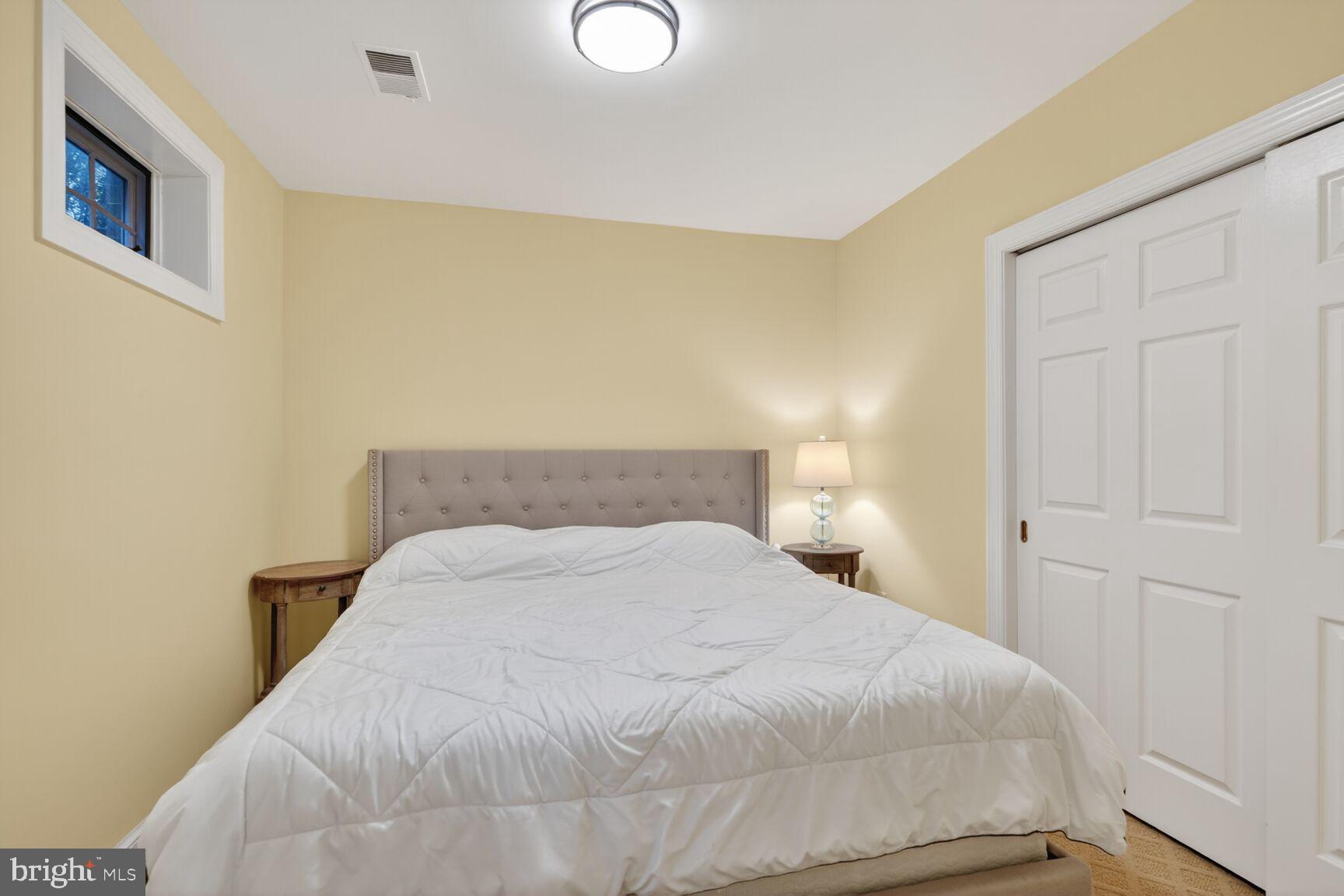 5206 Little Falls Road Arlington, VA 22207 - Photo 42 of 49 a large bed sitting in a bedroom next to a window