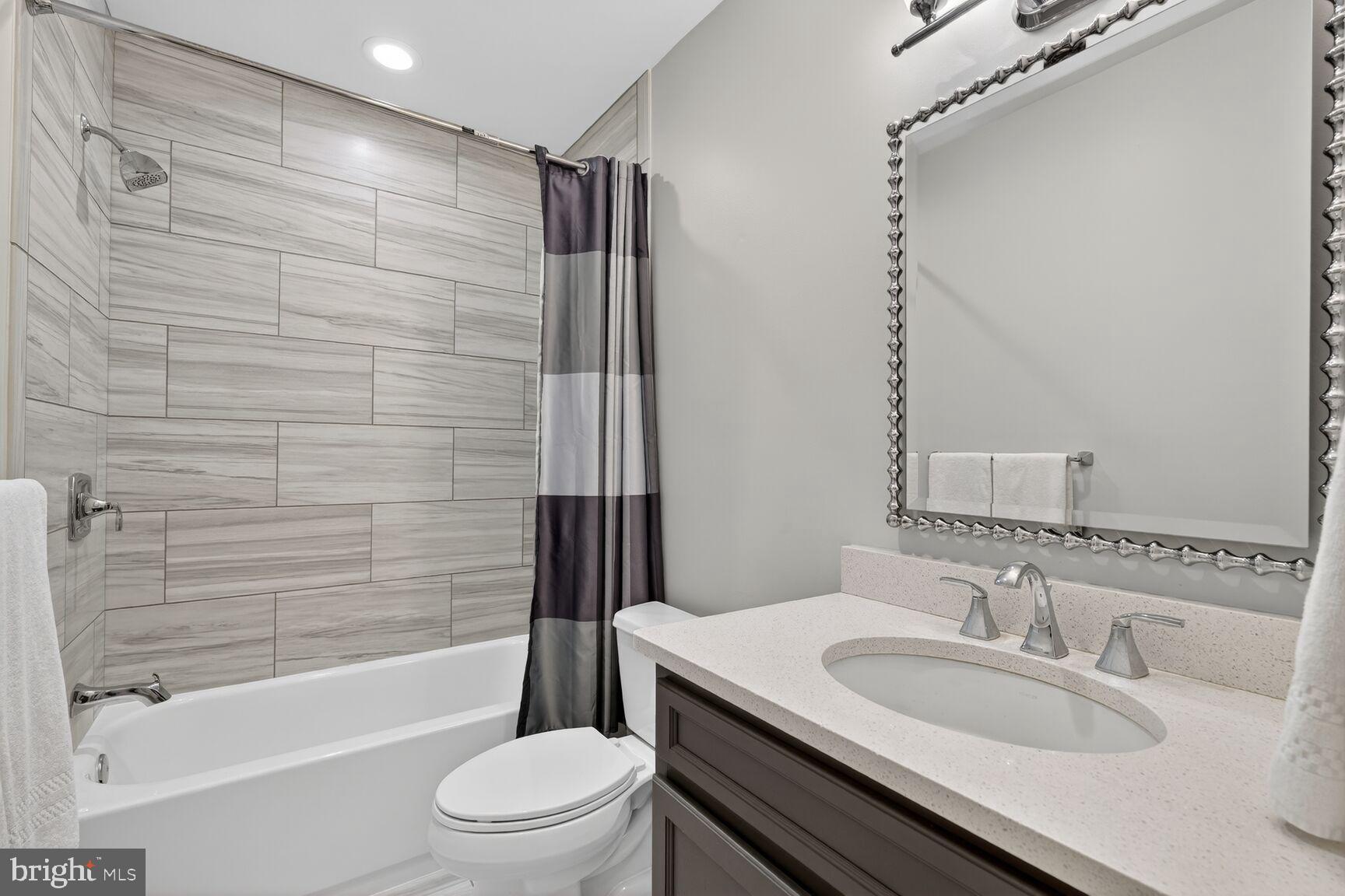 5206 Little Falls Road Arlington, VA 22207 - Photo 43 of 49 a bathroom with a granite countertop sink toilet and shower