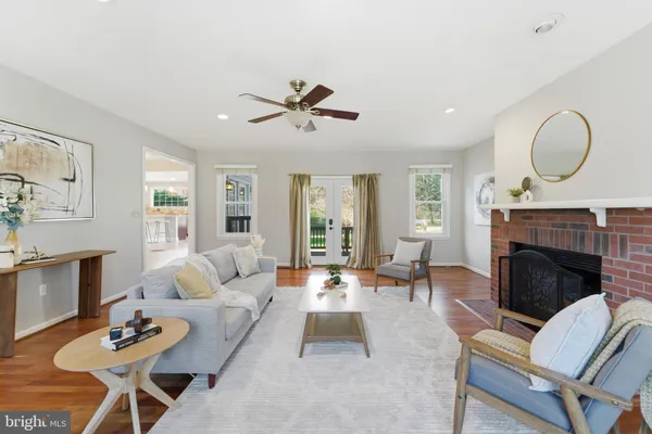 a living room with furniture a fireplace with wooden floor