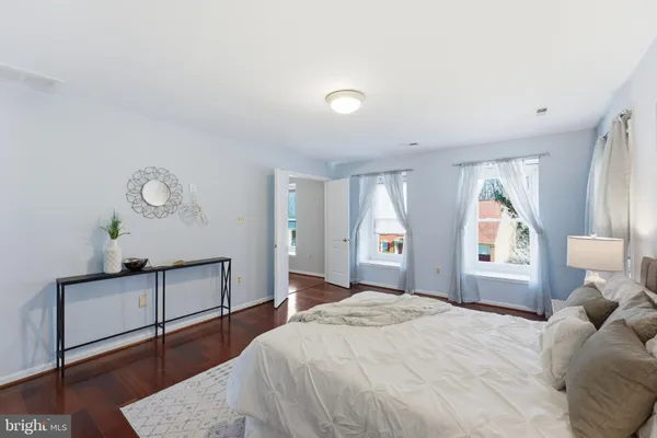 a bedroom with a large bed and a window