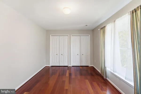 a view of a room with wooden floor and window