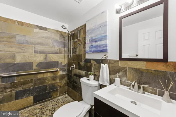 a bathroom with a sink toilet and shower