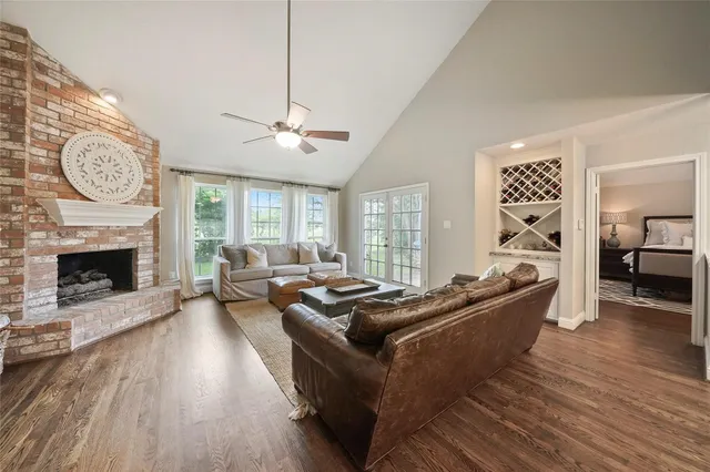 a living room with furniture a fireplace and a window