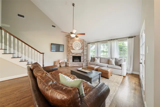 a living room with furniture a fireplace and a chandelier