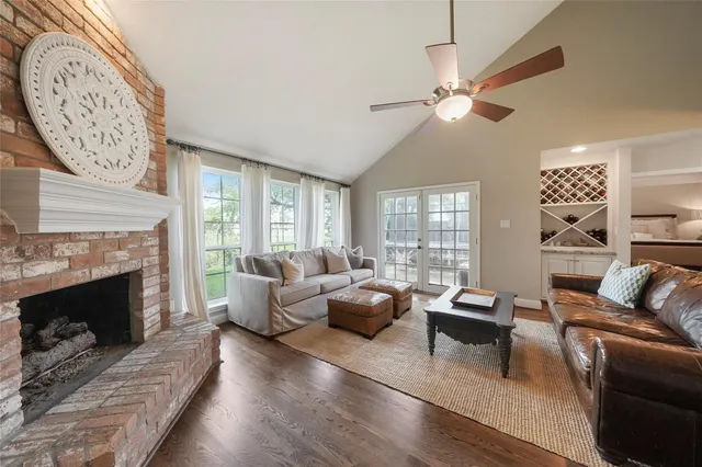 a living room with furniture a fireplace and a large window