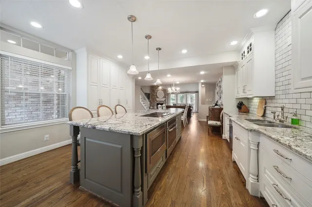 a kitchen with a sink and wooden floor
