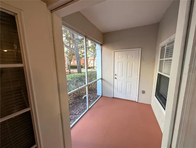 a view of a room with window and wooden floor