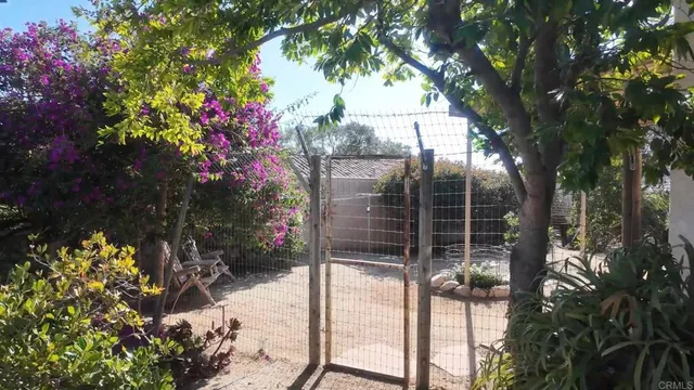 a kitchen with stainless steel appliances granite countertop a stove top oven a sink and a refrigerator