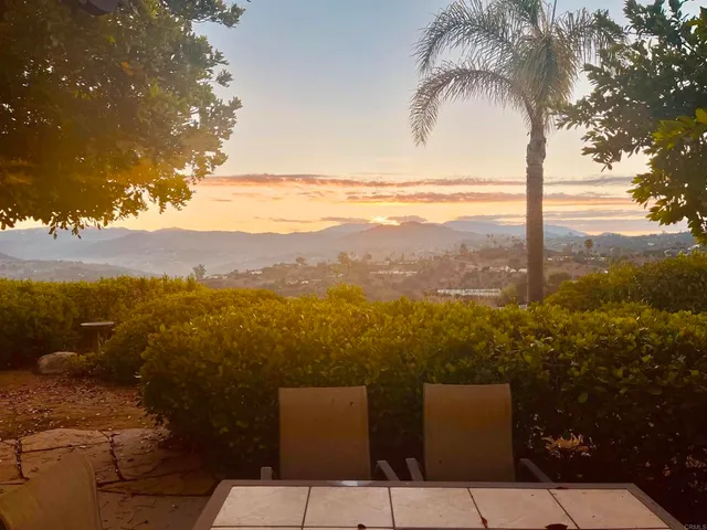 a kitchen with a sink a microwave a refrigerator and wooden cabinets