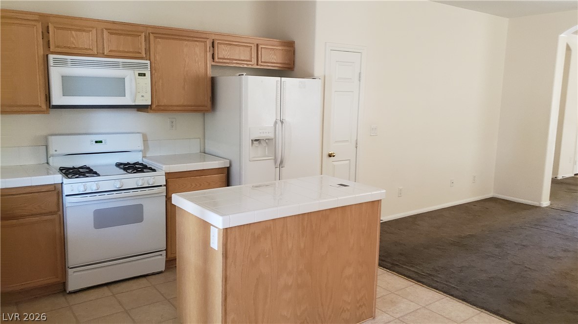 9112 Manalang Road Las Vegas, NV 89123 - Photo 32 of 50 Functional kitchen with ample cabinetry, a central island, and a full suite of appliances.