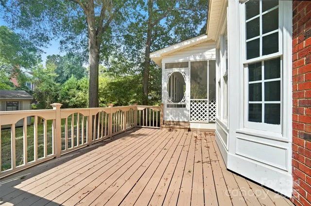 a view of a wooden deck with a yard