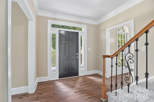 a view of an entryway with wooden floor and stairs