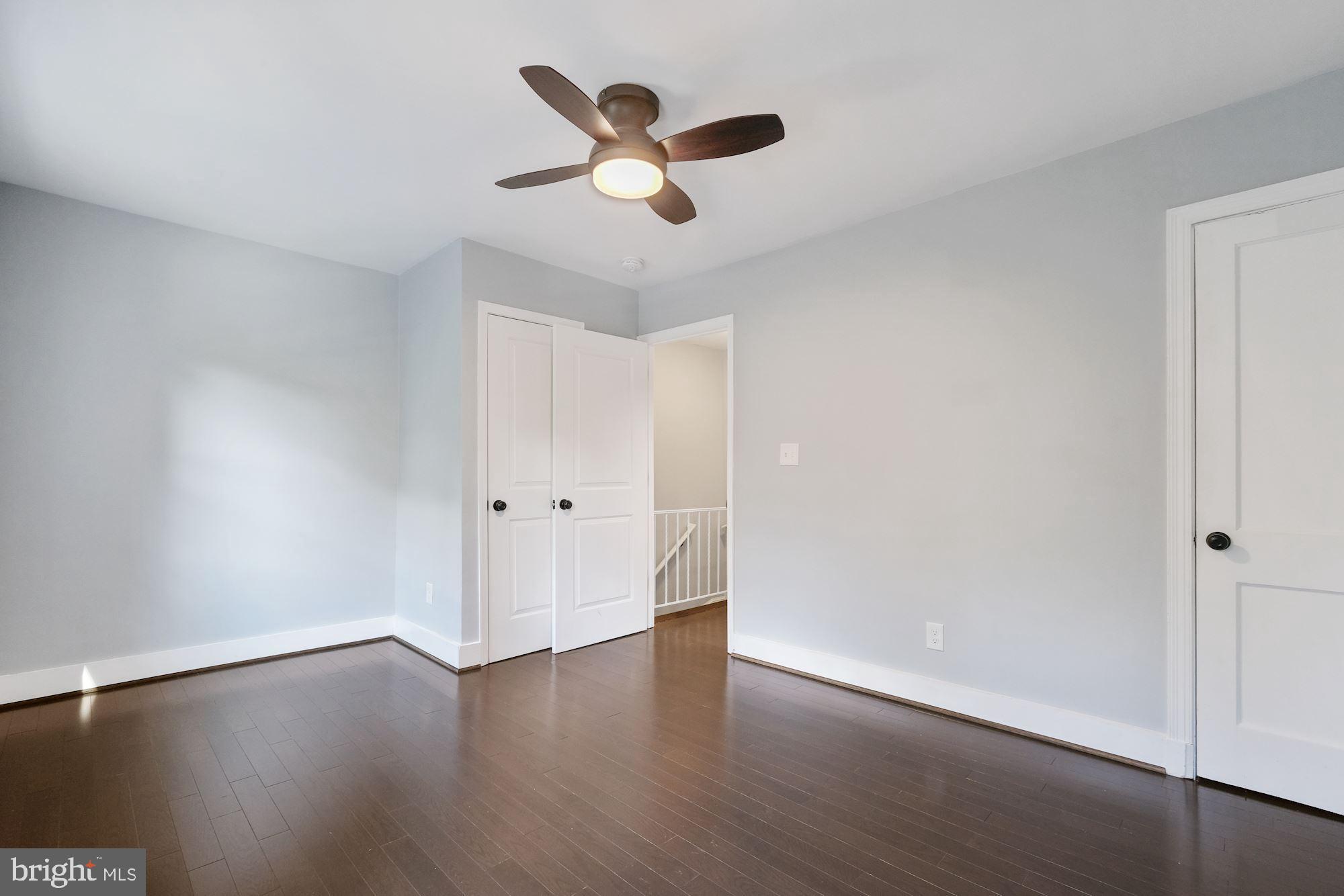 3158 M Place Southeast Washington, DC 20019 - Photo 12 of 22 a view of a livingroom with wooden floor and a ceiling fan