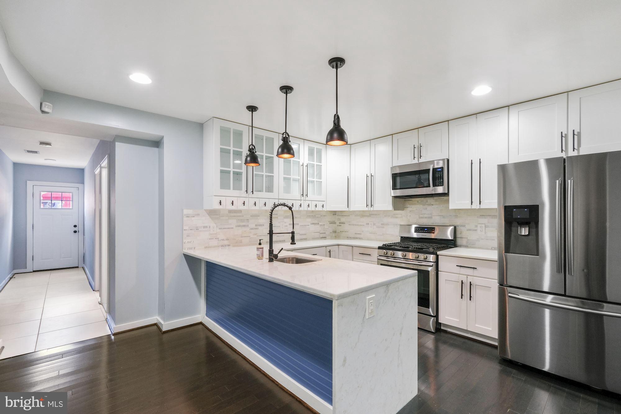 3158 M Place Southeast Washington, DC 20019 - Photo 3 of 22 a kitchen with kitchen island a sink appliances and cabinets