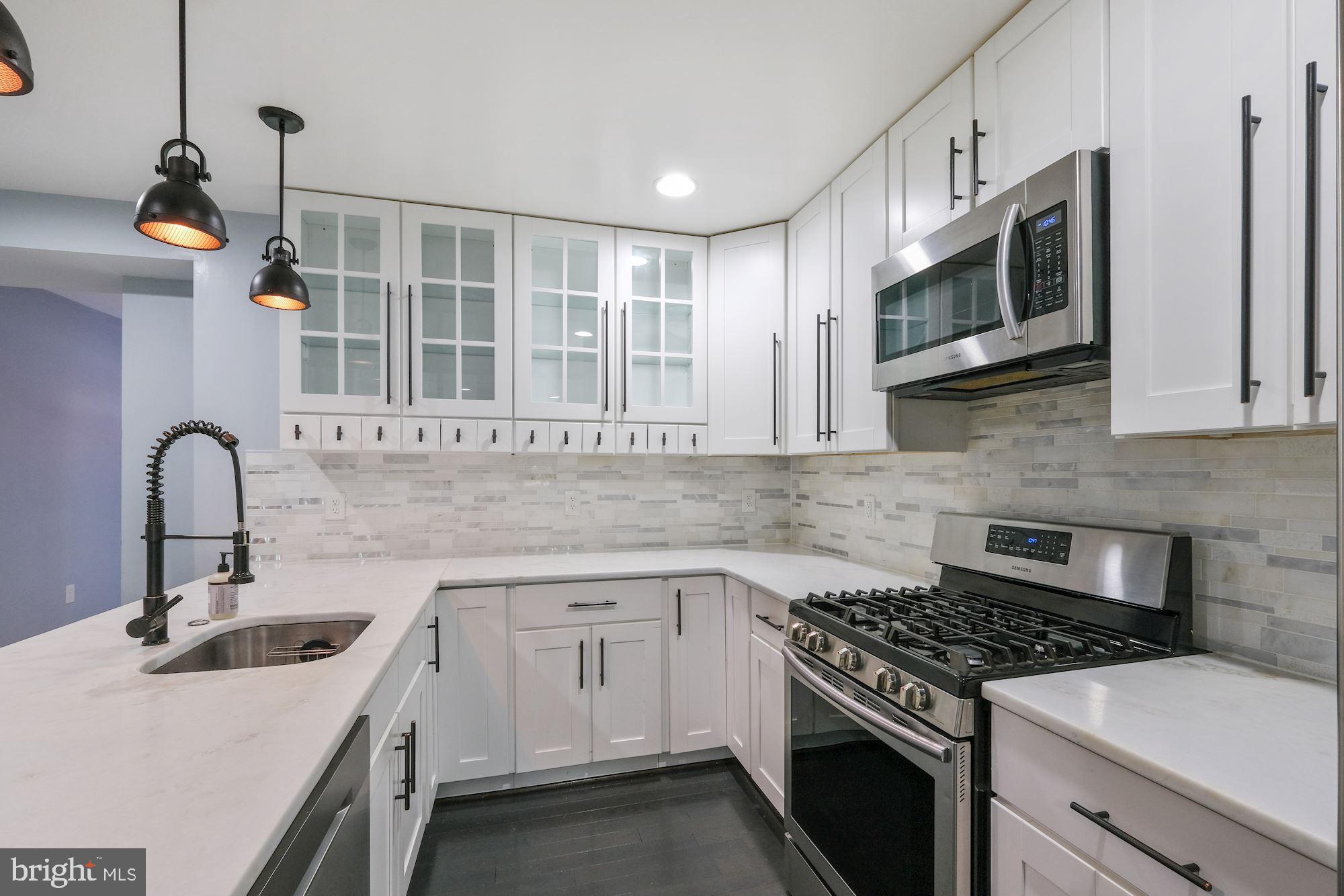 3158 M Place Southeast Washington, DC 20019 - Photo 4 of 22 a kitchen with stainless steel appliances granite countertop a stove and a sink