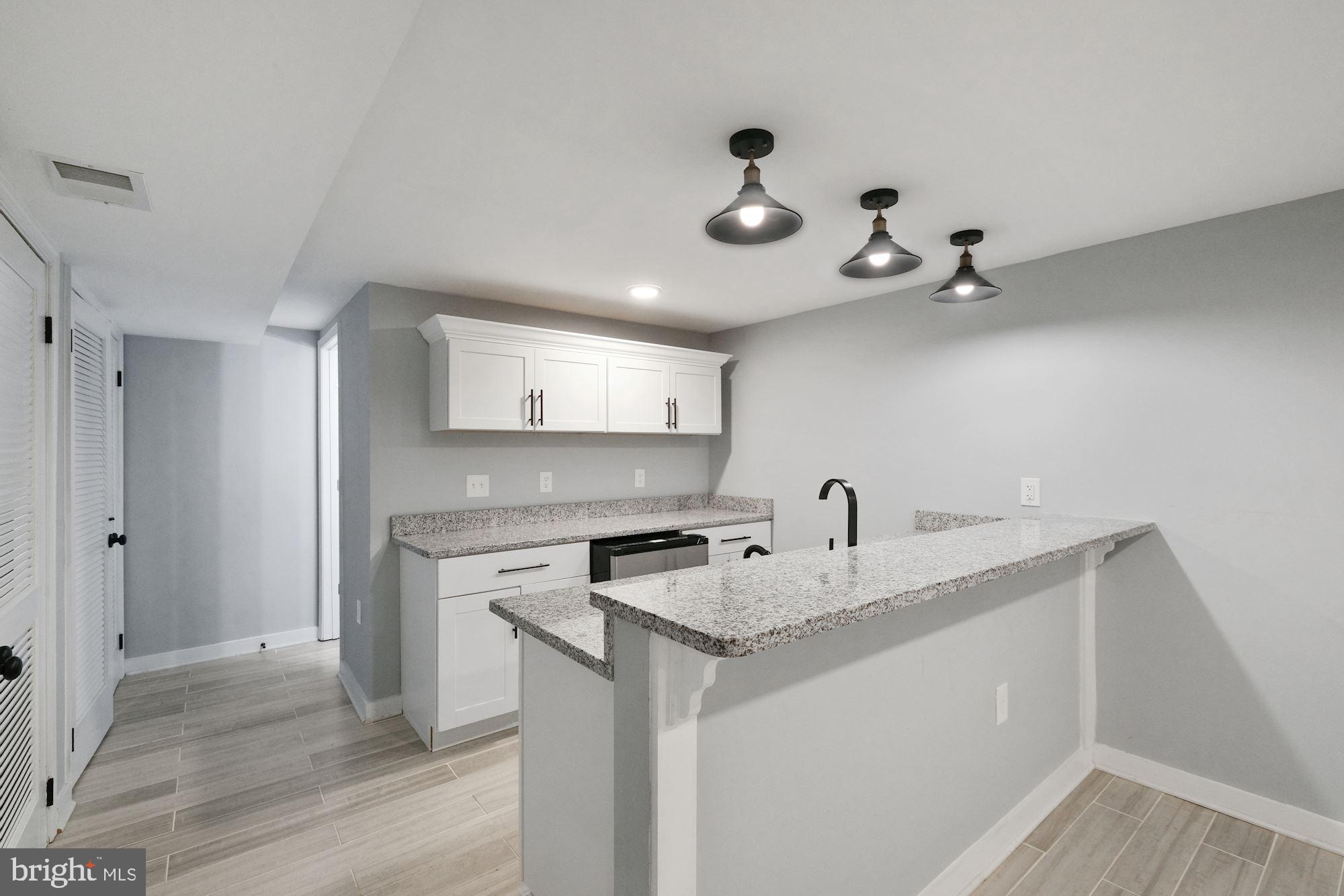 3158 M Place Southeast Washington, DC 20019 - Photo 8 of 22 a kitchen with a sink a stove and cabinets