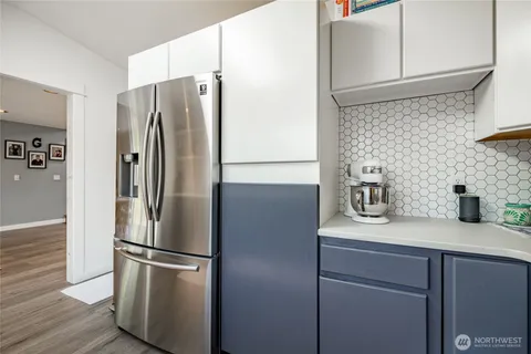 a metallic refrigerator freezer sitting in a kitchen