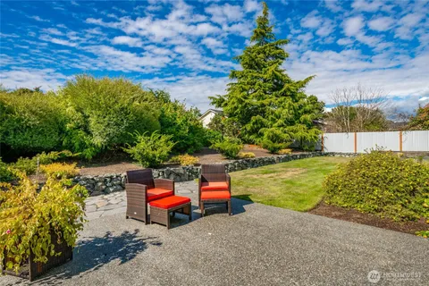 a backyard of a house with outdoor seating