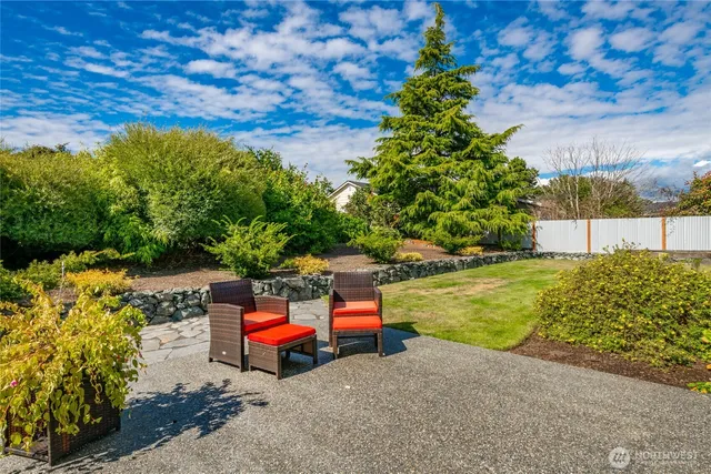 a backyard of a house with outdoor seating