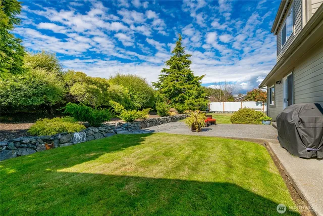 a view of a backyard with swimming pool