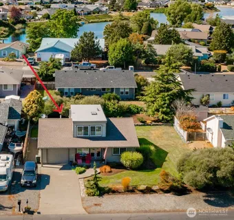 an aerial view of a house with a garden and lake view