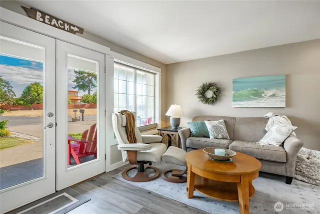 a living room with furniture and a painting on the wall