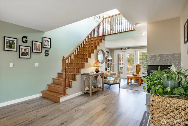 a view of entryway livingroom and hall with wooden floor