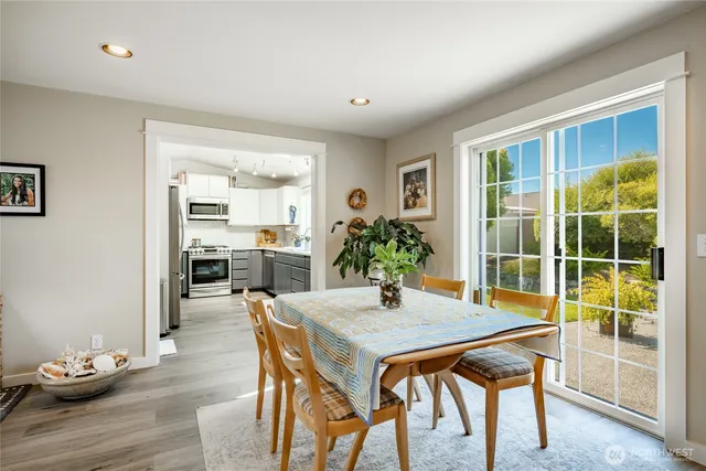 a view of a dining room with furniture and wooden floor