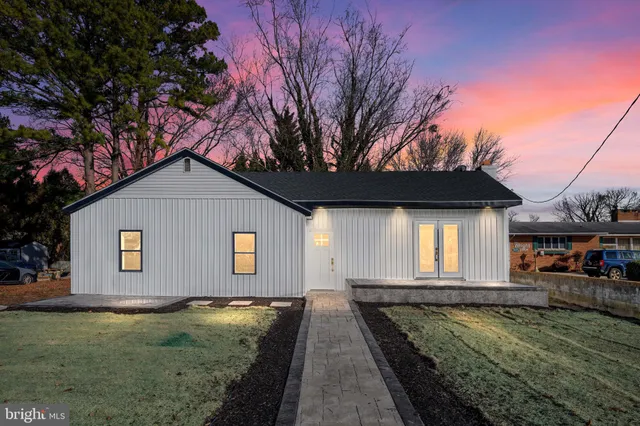 a view of a white house with a yard