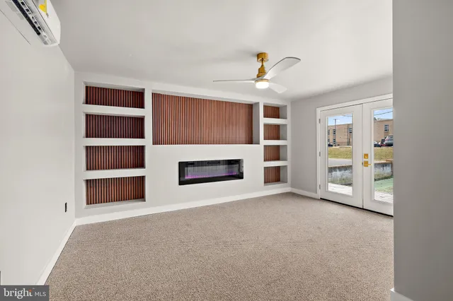 a view of an empty room with a fireplace and a window