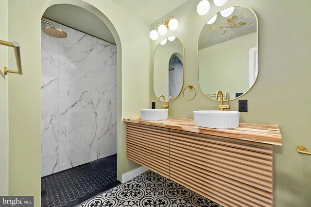 a bathroom with a sink a mirror and shower