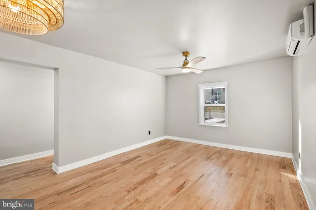 a view of a room with wooden floor and fan