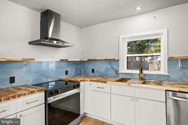 a kitchen that has a sink and a stove