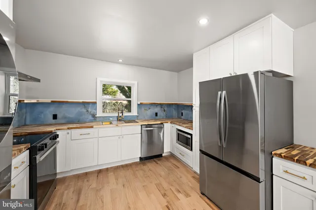 a kitchen with a refrigerator and a sink