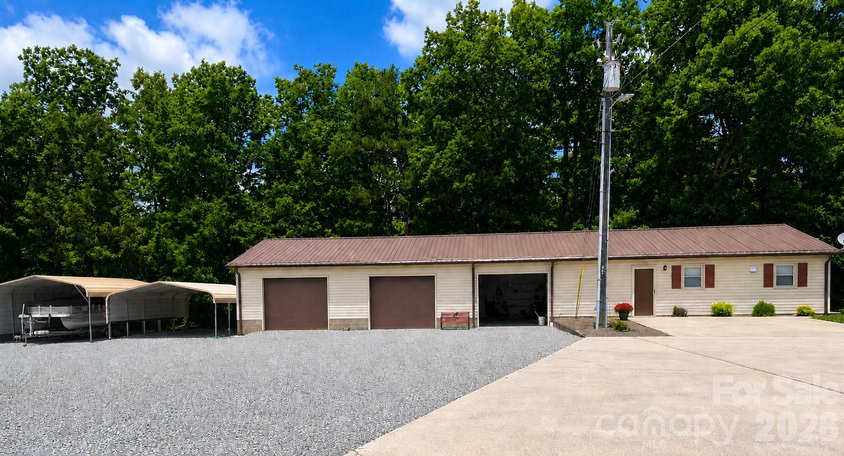 1368 Cajah Mountain Road Hudson, NC 28638 - Photo 34 of 46 a front view of a house with a yard and garage